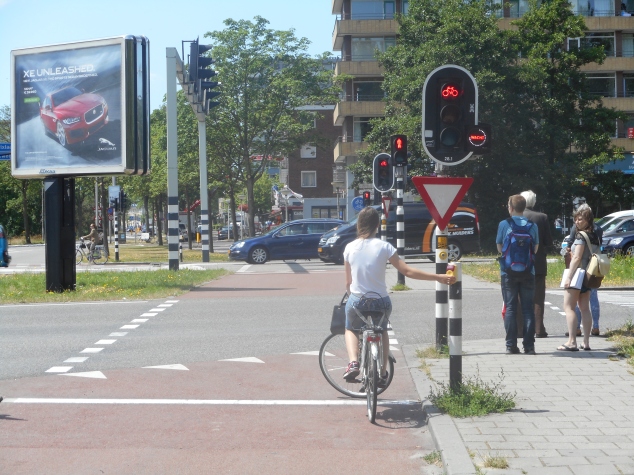 Cyclist in Delft waiting at the watch signal
